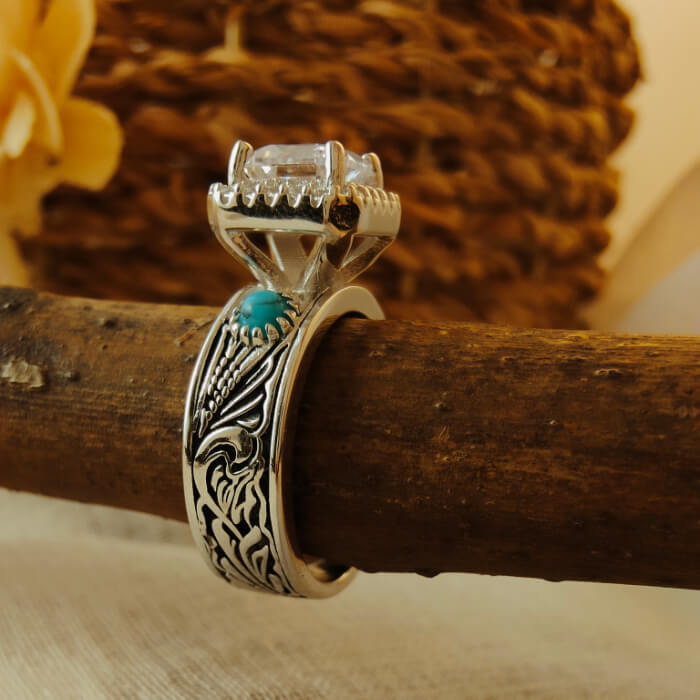 Turquoise ring with radiant diamond and intricate silver floral engraving