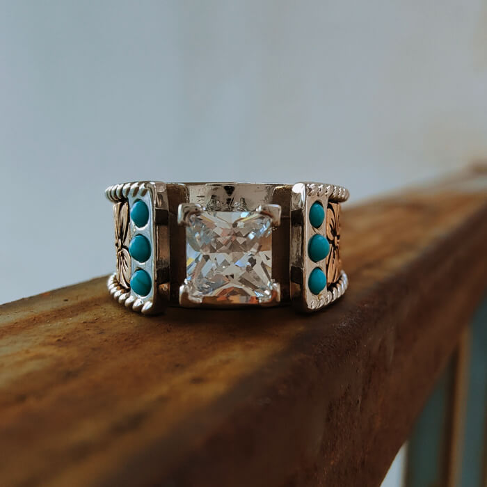 Western turquoise and diamond ring with intricate floral design and turquoise accents