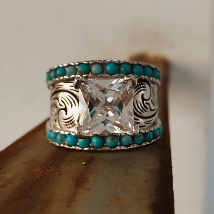 Flower engraved turquoise band ring with large clear stone