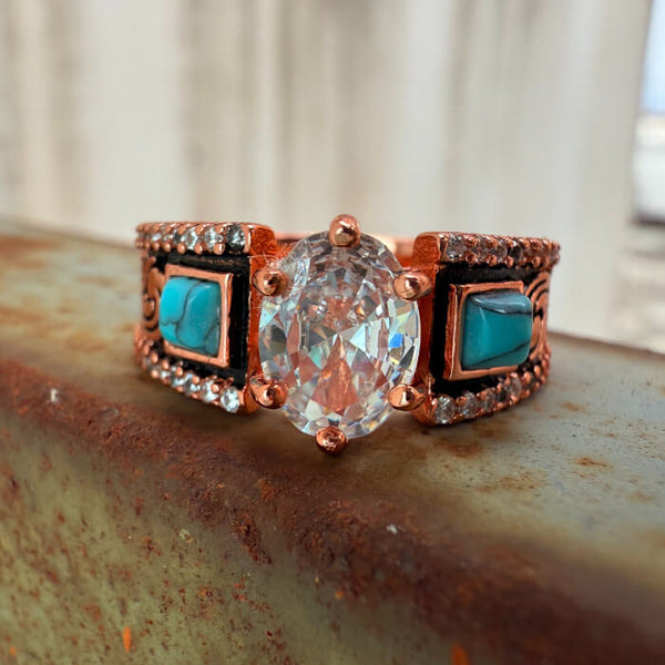 Rose gold engagement ring with oval zircon, turquoise stones, and diamond accents