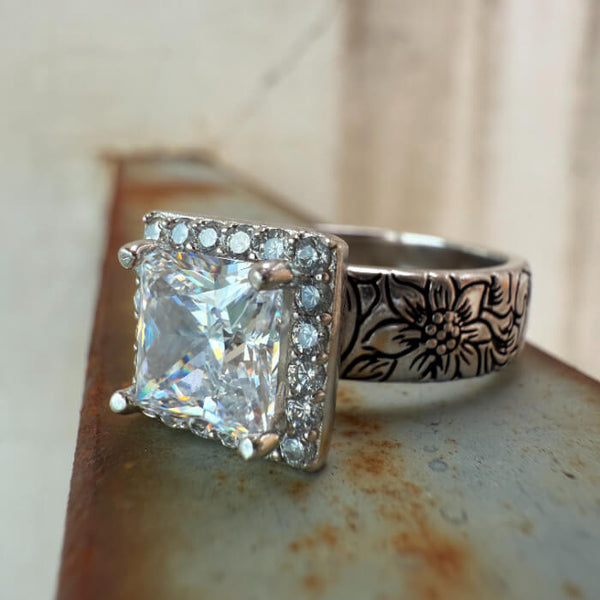 Western square engagement ring with diamond halo and floral engraved band