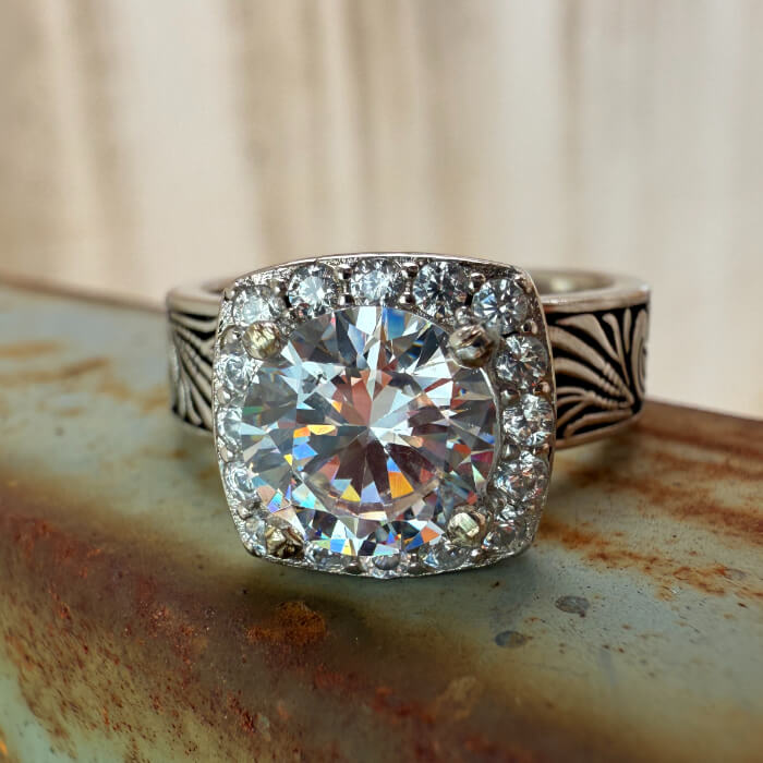 7mm engagement ring with cubic zirconia center and diamond halo on ornate silver band