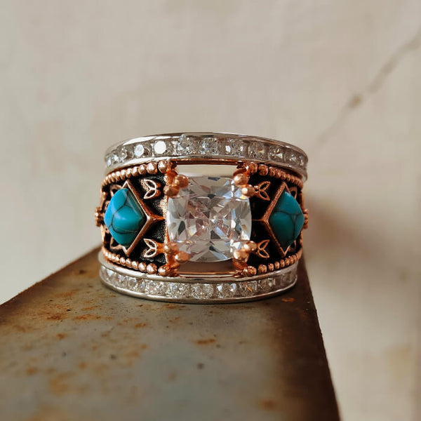 Rose gold engagement ring featuring turquoise stones and diamond accents