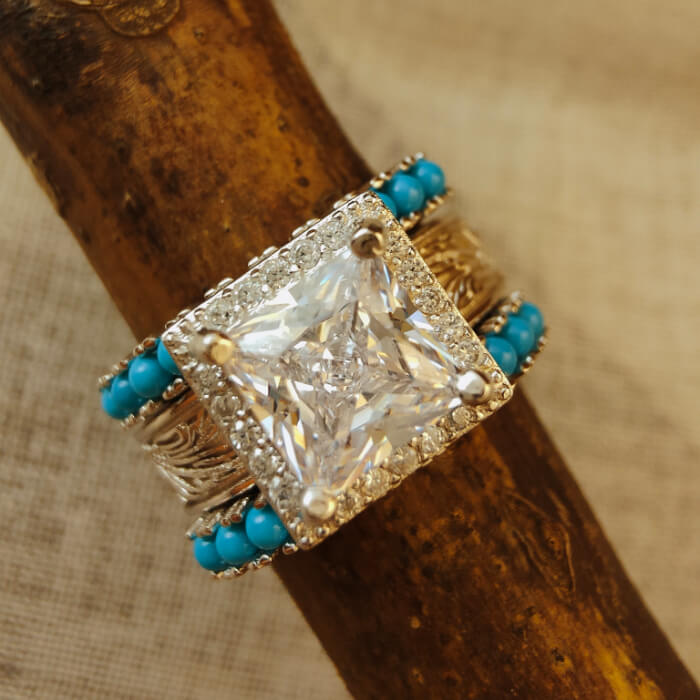 Princess cut diamond ring with turquoise accents and ornate silver band