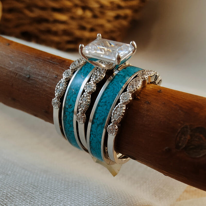 Sterling silver vintage ring set featuring turquoise and diamond accents stacked on wood.