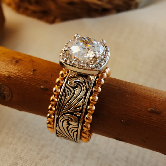Rose gold wedding ring set featuring a round diamond and floral engraving