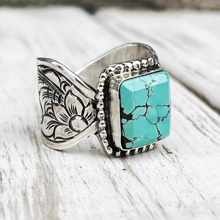 Rectangular turquoise ring with floral engravings in polished silver