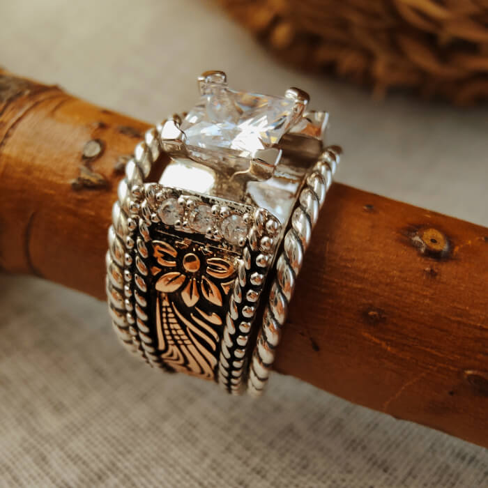 Sterling silver twist band ring featuring square diamond and floral engraving