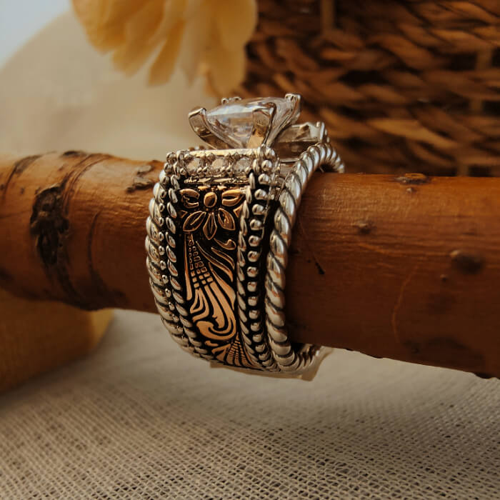 Sterling silver twist band ring with square diamond and detailed floral engravings