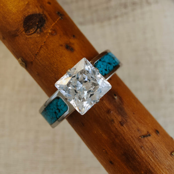 Steel wedding ring with princess cut zircon and turquoise inlays.