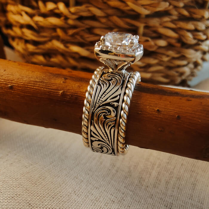 Sterling silver engagement ring with twist design and diamond centerpiece.
