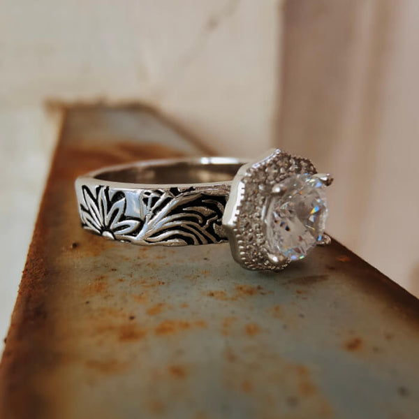 Silver floral engraved engagement ring with large zircon gemstone