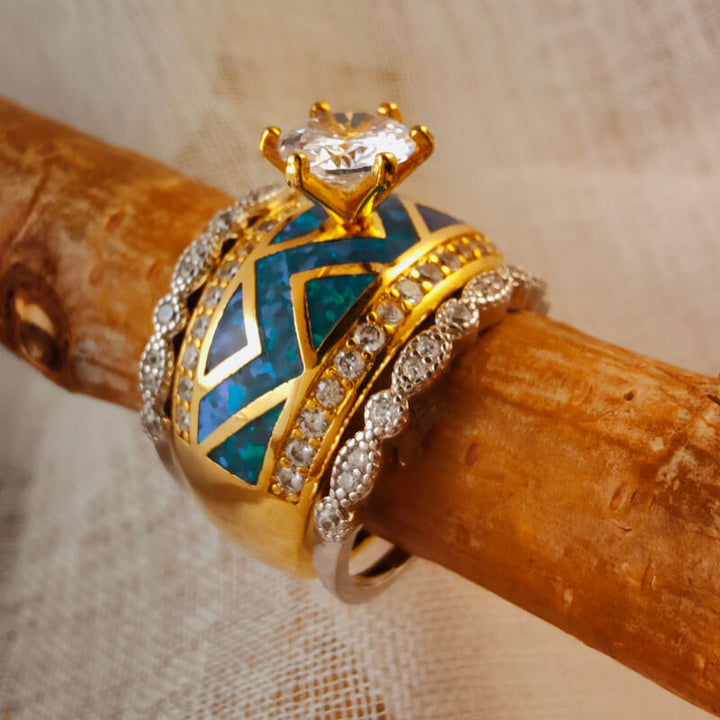Gold and turquoise ring with diamond accents on a wooden background