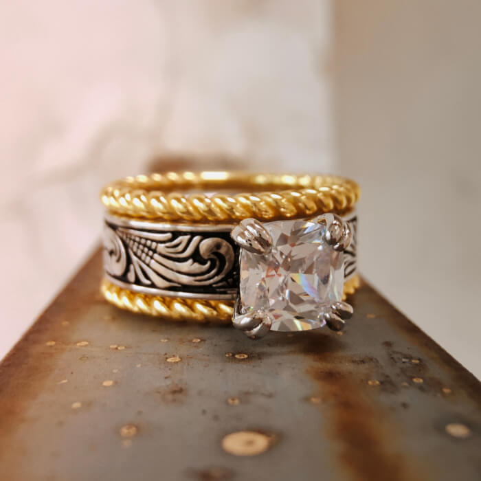 Western-inspired ring with emerald cut zircon and ornate floral band design
