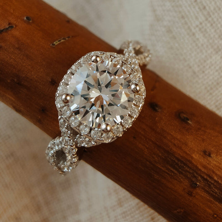Sterling silver ring with round moissanite center and diamond accents