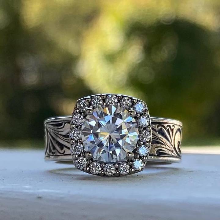 Vintage round diamond ring with intricate floral engravings and halo setting