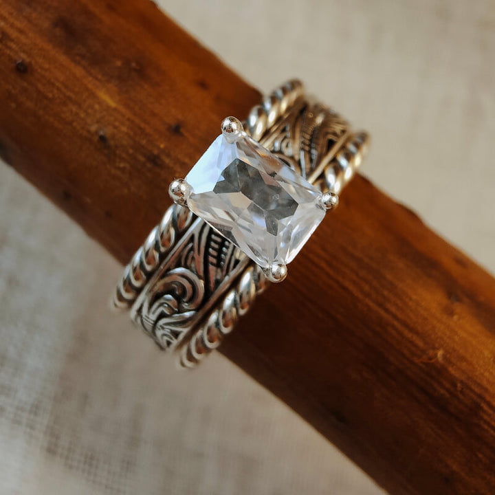 Three-piece silver wedding ring set featuring rectangular zircon stone