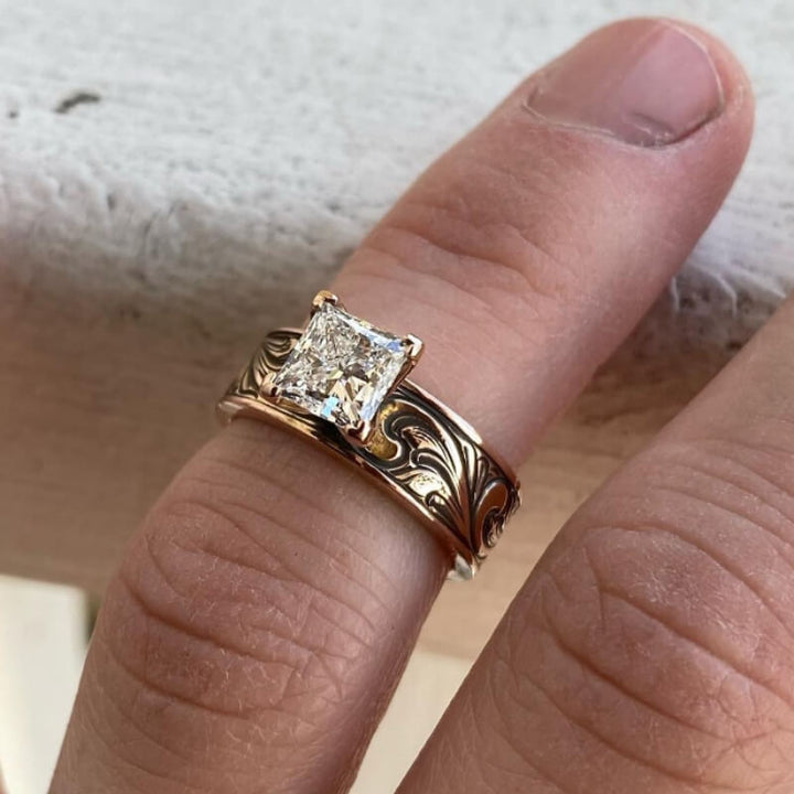 Rose gold wedding ring featuring a square zircon stone and floral engravings.
