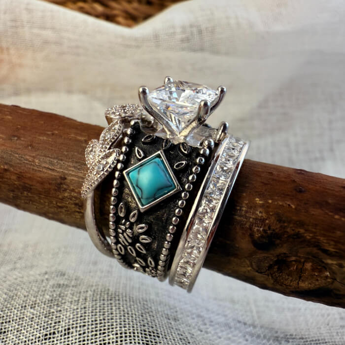 Three-piece turquoise engagement ring set featuring square and round accents