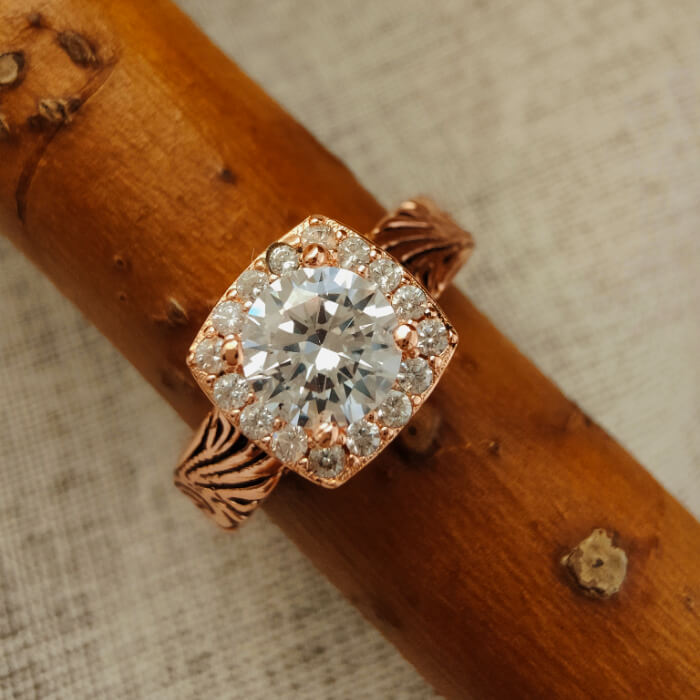 Rose gold ring featuring a large zircon surrounded by smaller zircon stones