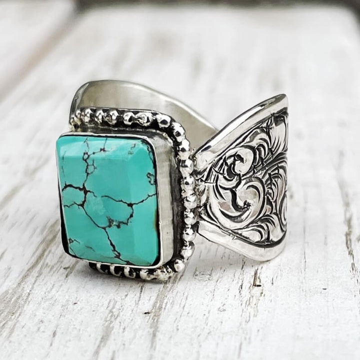 Rectangular turquoise ring with detailed flower wave band in sterling silver