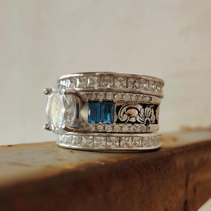 Flower engraved wide band engagement ring with sapphire and diamond accents