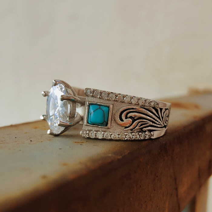 Silver engagement ring with oval zircon and turquoise inlay, ornate band design