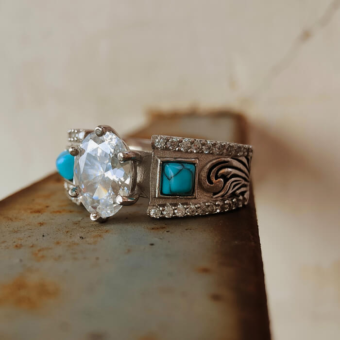 Oval zircon engagement ring with turquoise details and ornate silver band