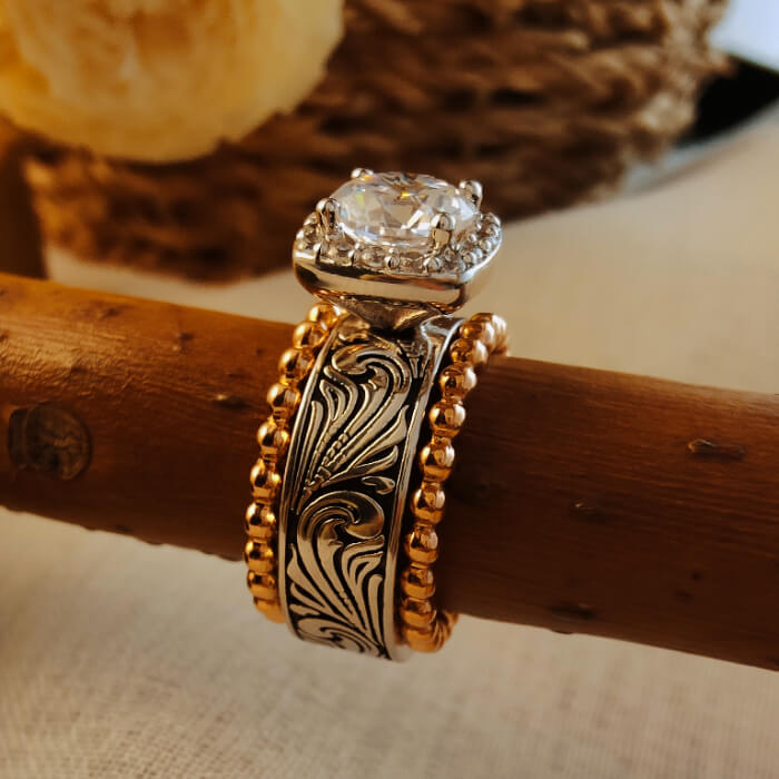 Western wedding ring set with floral engravings and round diamond halo