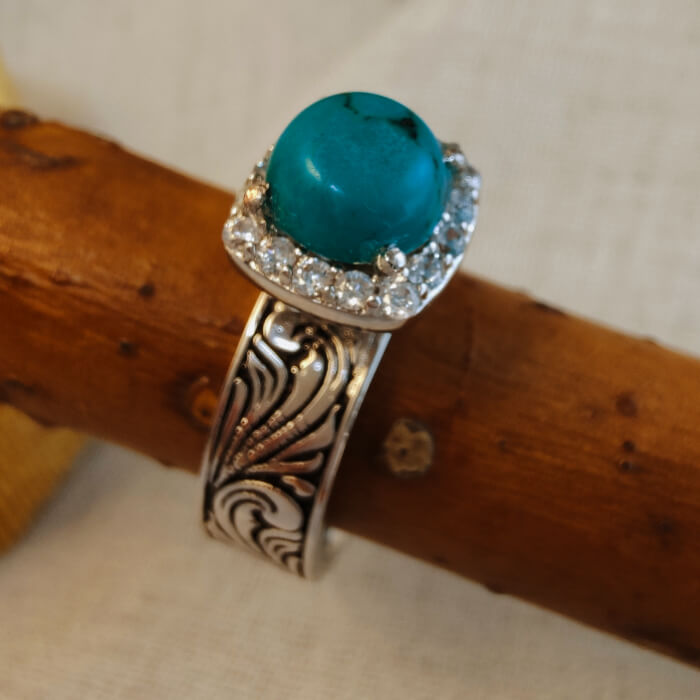 Turquoise ring with diamond halo and floral engraved silver-black band