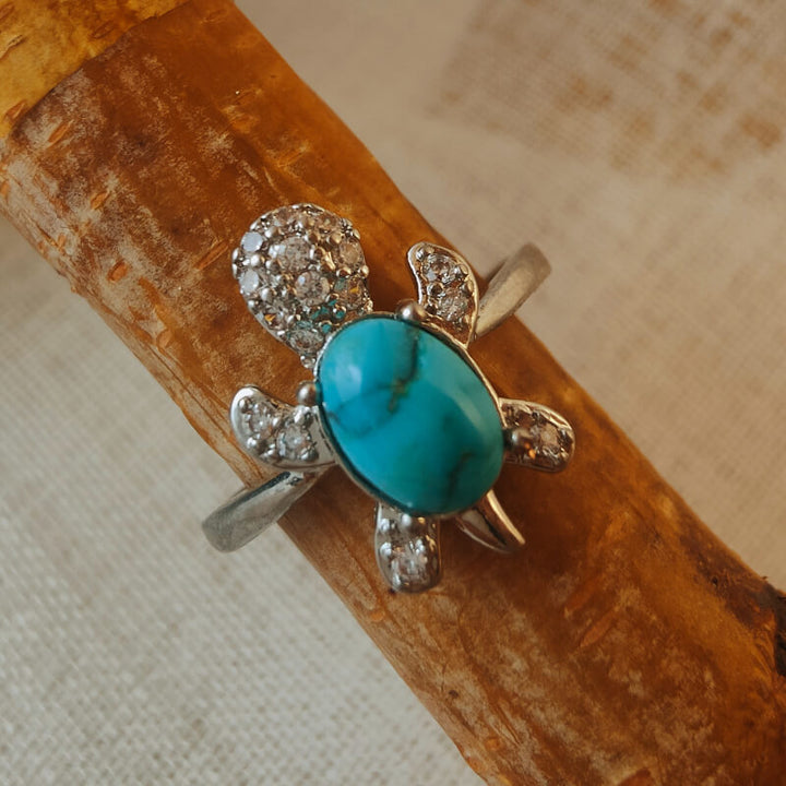 Turquoise turtle ring with diamond accents in a silver band