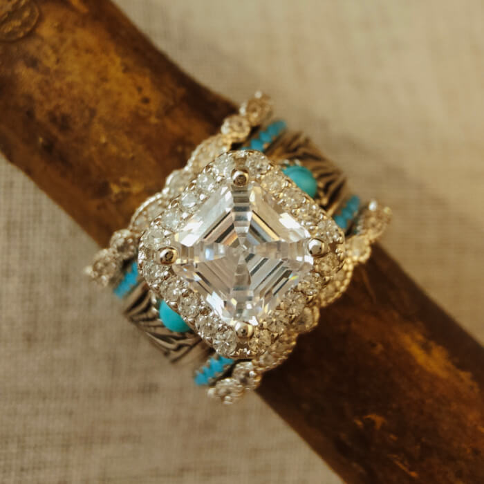 Radiant cut diamond and turquoise bridal set on textured surface