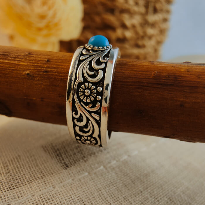 Western-style steel ring with turquoise stone and floral engravings