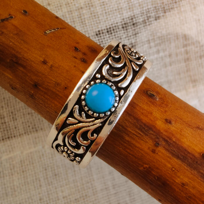 Western turquoise band ring with intricate flower engravings on silver steel