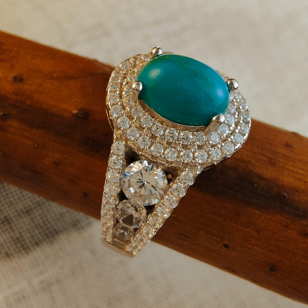 Sterling silver ring with oval blue turquoise and diamond accents