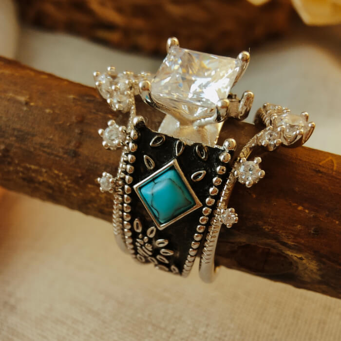 Turquoise square ring with diamond accents and ornate silver details