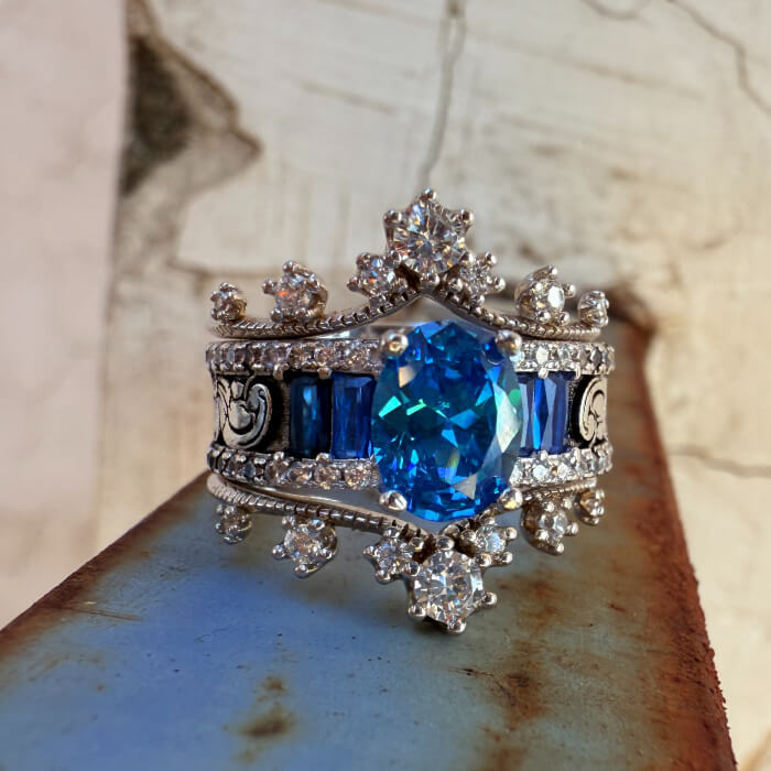 Ornate octagonal blue sapphire ring with diamond accents in silver setting