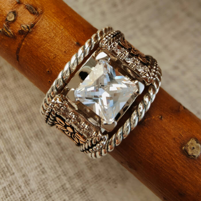 Sterling silver engagement ring with square diamond and floral twist band design