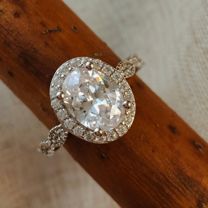 Close-up of vintage oval moissanite ring with diamond accents in sterling silver
