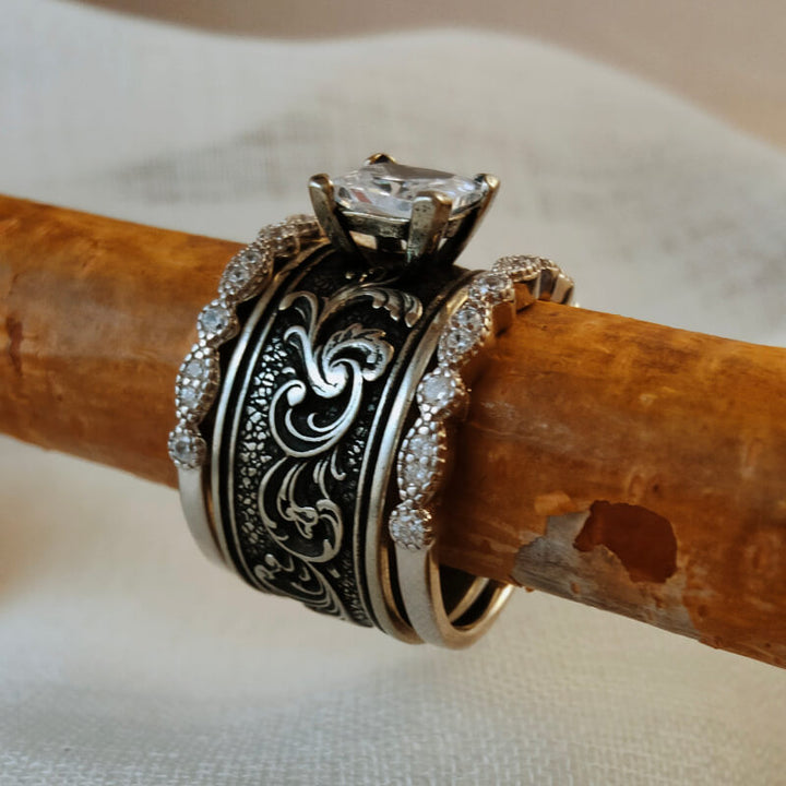 Western-style sterling silver wedding ring set with floral engravings and sparkling zirconia