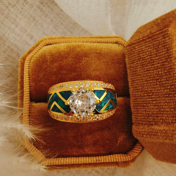 Blue opal diamond ring in velvet box with geometric design and sparkling accents