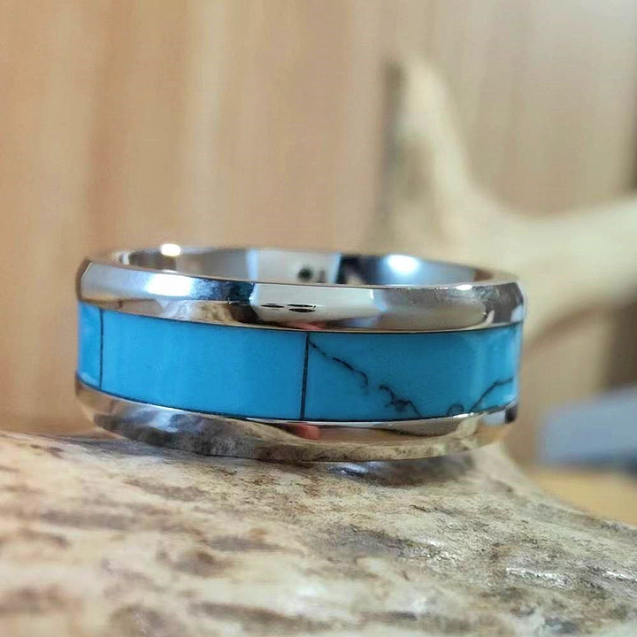 Inlaid turquoise band ring with vibrant blue segments and sleek silver edges.