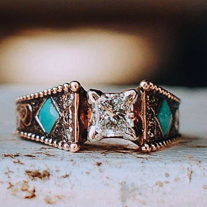 Engraved turquoise engagement ring with diamond and turquoise accents on rose gold band.