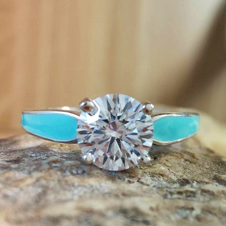 Sterling silver round cut moissanite ring with turquoise side details