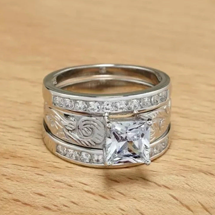 Western diamond wide band ring with zircon center and engraved details on wood