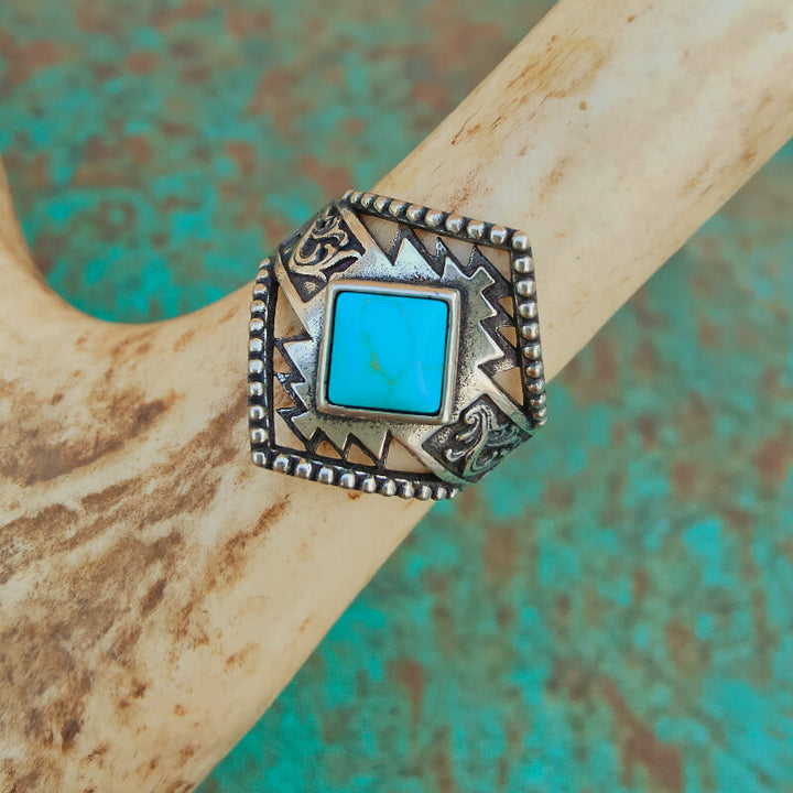 Sterling silver ring with square turquoise stone and ornate engravings