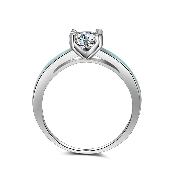 Sterling silver engagement ring with round moissanite and turquoise side accents.