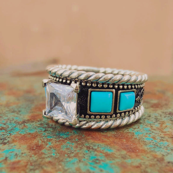 Twisted silver ring with large clear diamond and blue turquoise accents