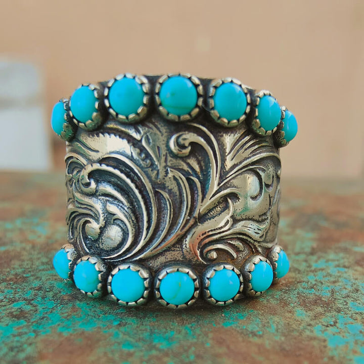 Floral engraved silver cuff bracelet with turquoise stone accents