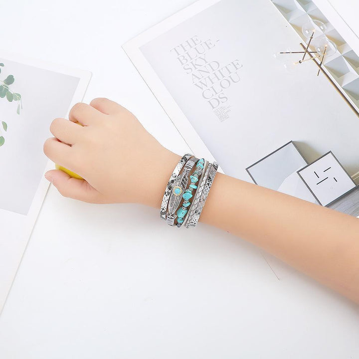 Hand showcasing vintage turquoise and silver leather bracelet with a magnet clasp